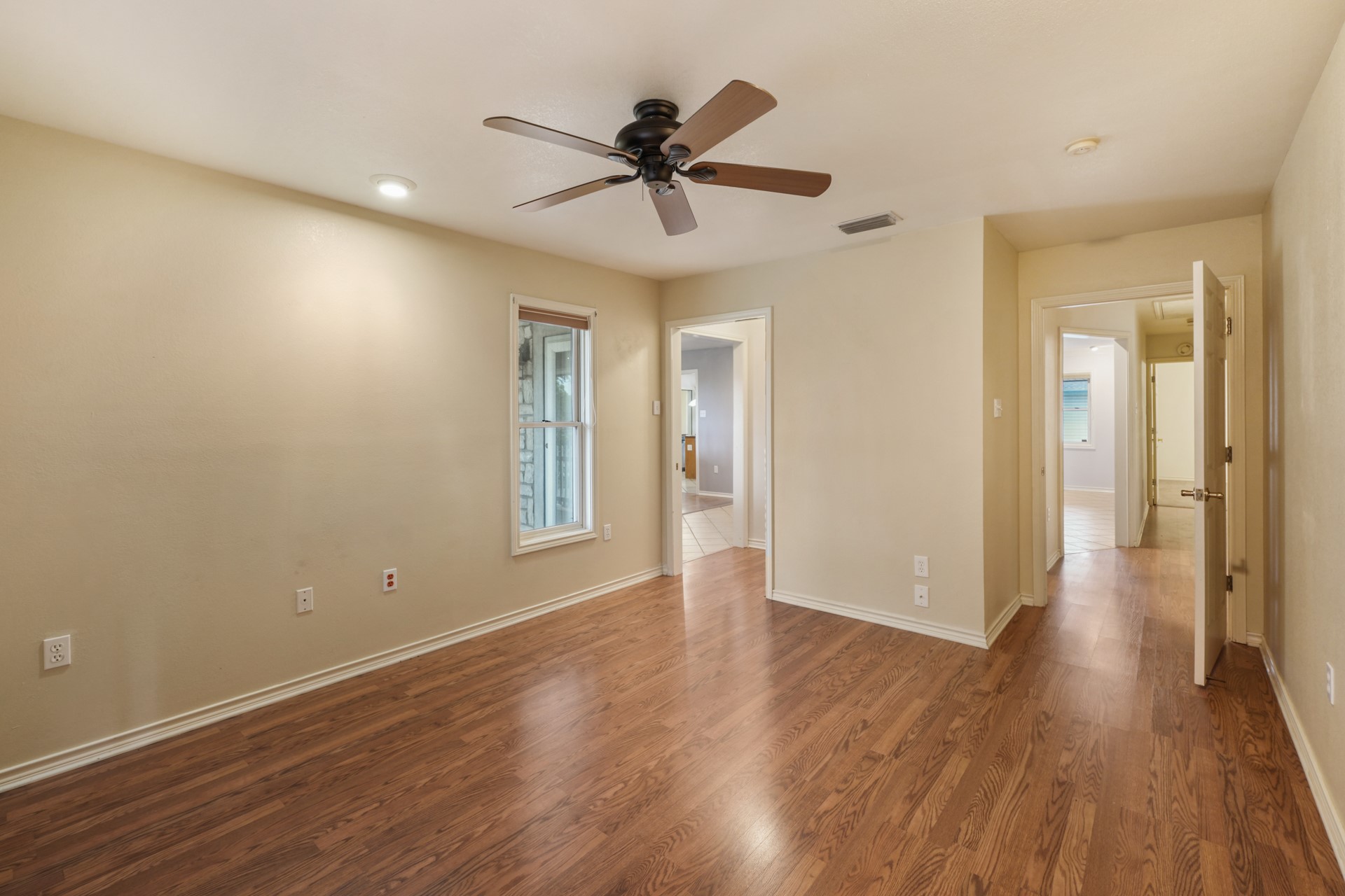 6625 East Post Road Kyle, TX 78640 - Photo 24 of 46 a view of a room with wooden floor and a ceiling fan