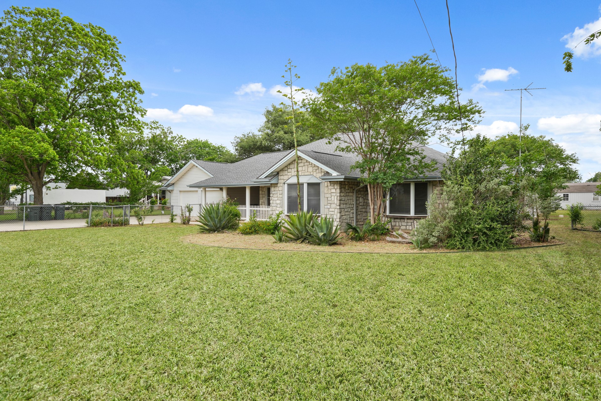 6625 East Post Road Kyle, TX 78640 - Photo 3 of 46 a front view of a house with garden