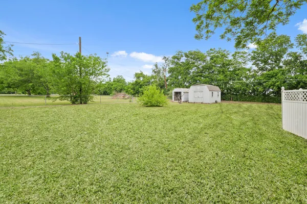 a front view of a house with yard and green space
