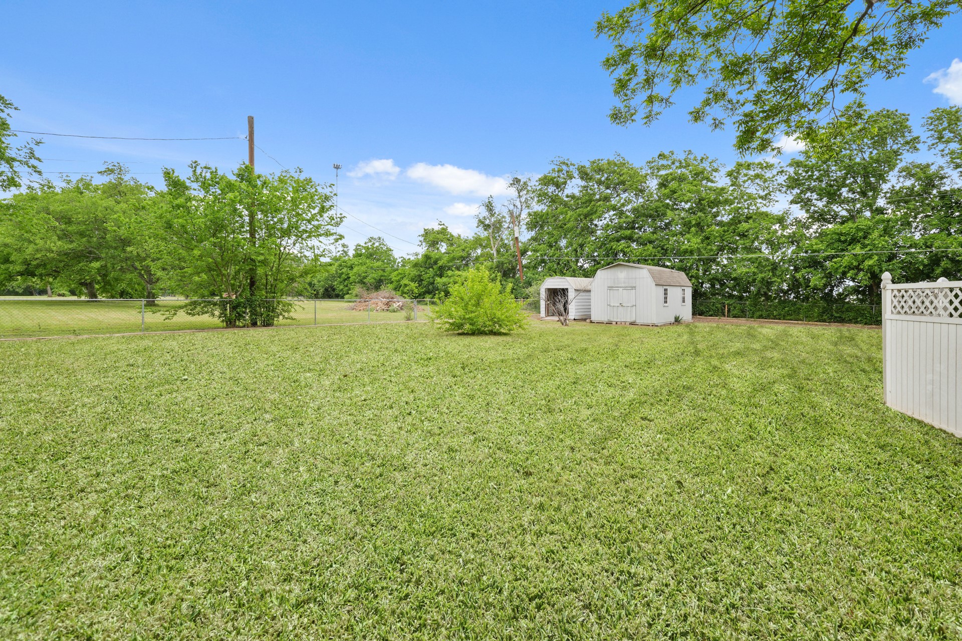 6625 East Post Road Kyle, TX 78640 - Photo 33 of 46 a view of a field with an tree and a fence