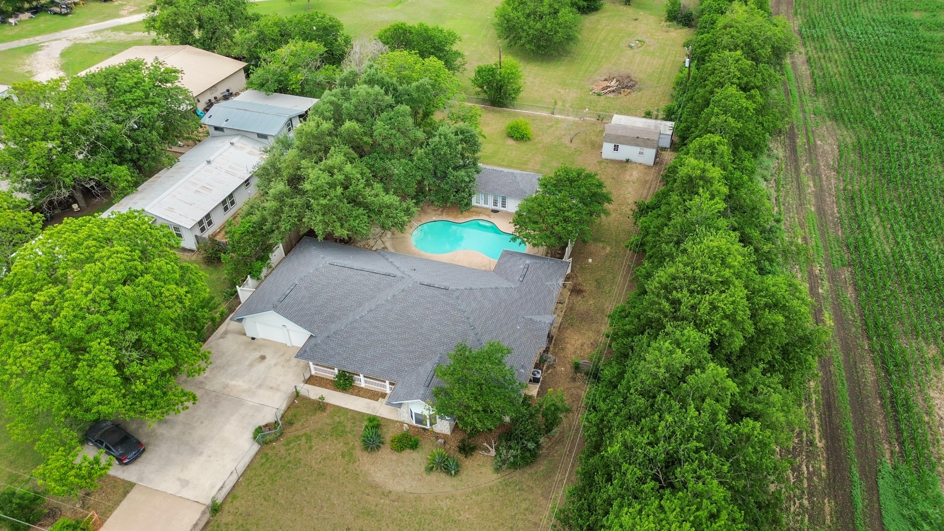 6625 East Post Road Kyle, TX 78640 - Photo 4 of 46 an aerial view of a house with a yard and trees all around