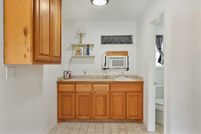a kitchen with a refrigerator and cabinets