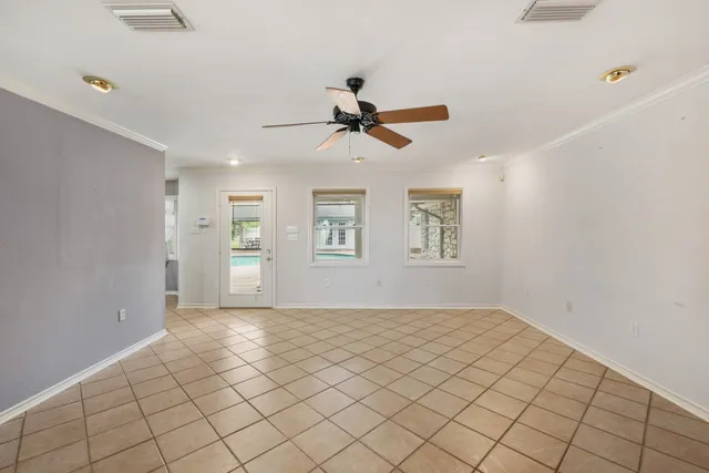 a view of a room with window ceiling fan