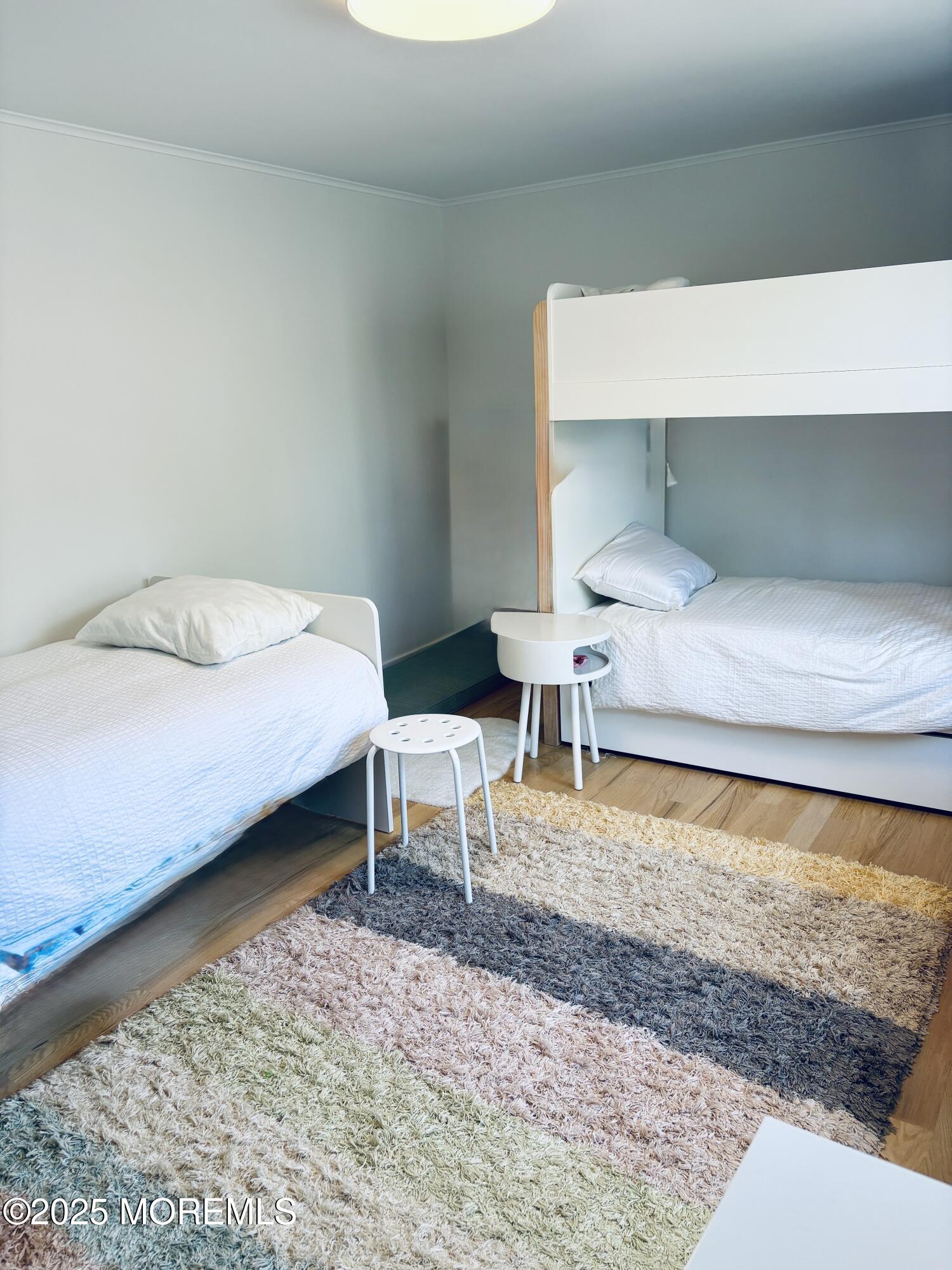 121 Bridge Avenue Bay Head, NJ 08742 - Photo 15 of 22 a bedroom with a bed and a chair