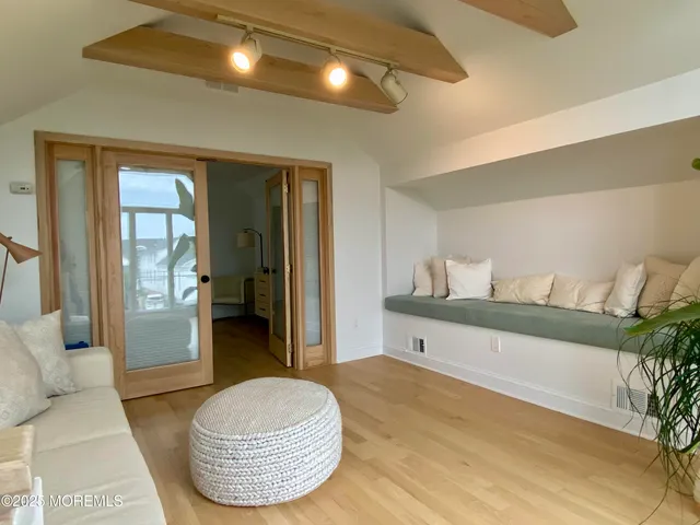 a living room with a couch and a potted plant