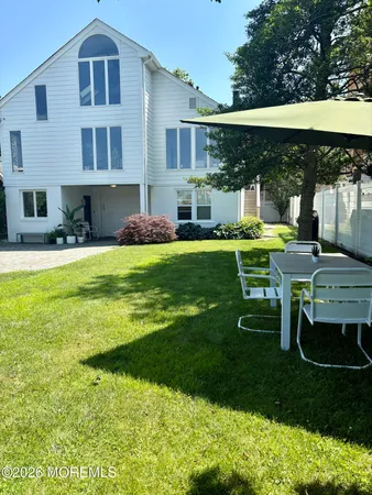 a view of a house with a yard porch and sitting area