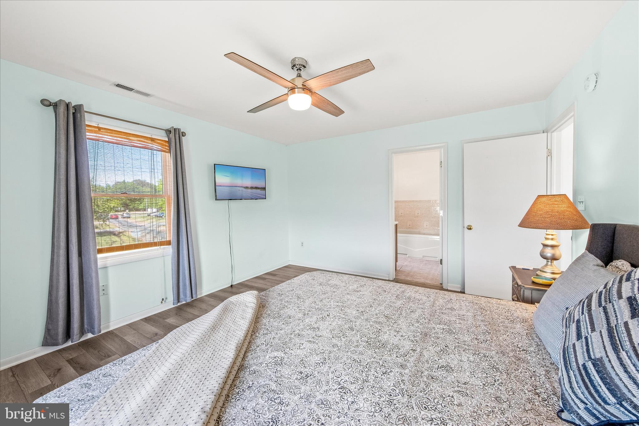 21406 Dogwood Cove Road Tilghman, MD 21671 - Photo 41 of 68 a bedroom with a bed and a window