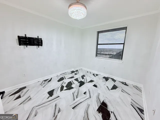 a view of a livingroom with wooden floor and window