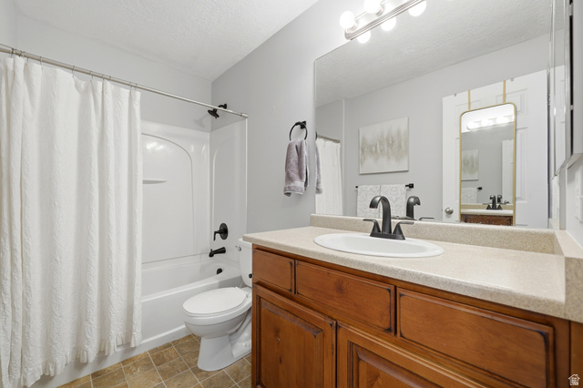 116 East Resaca Drive, Unit F6 Sandy, UT 84070 - Photo 22 of 32 Bathroom featuring a wood-finish vanity with a light-colored countertop and an integrated sink