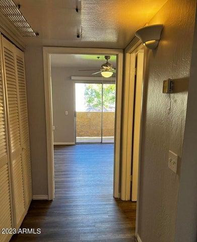 12221 West Bell Road, Unit 224 Surprise, AZ 85378 - Photo 6 of 12 a view of hallway with wooden floor