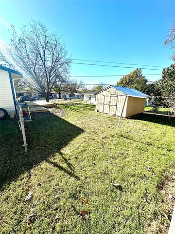 a view of a house with backyard and trees