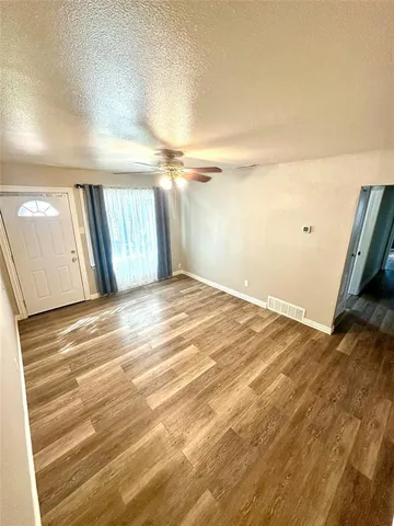 a view of a room with stairs and a wooden floor