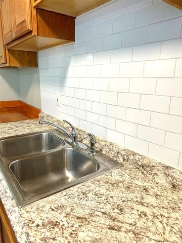 a view of a sink and an empty kitchen