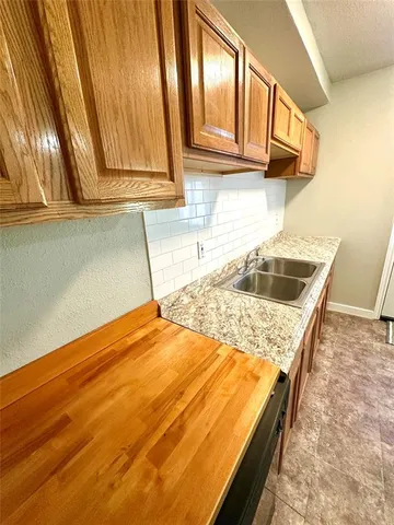 a kitchen with a sink and cabinets