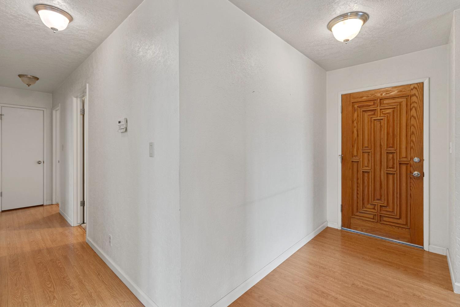 1428 Kent Way Modesto, CA 95355 - Photo 13 of 27 Front door and hallway leading to the bedrooms