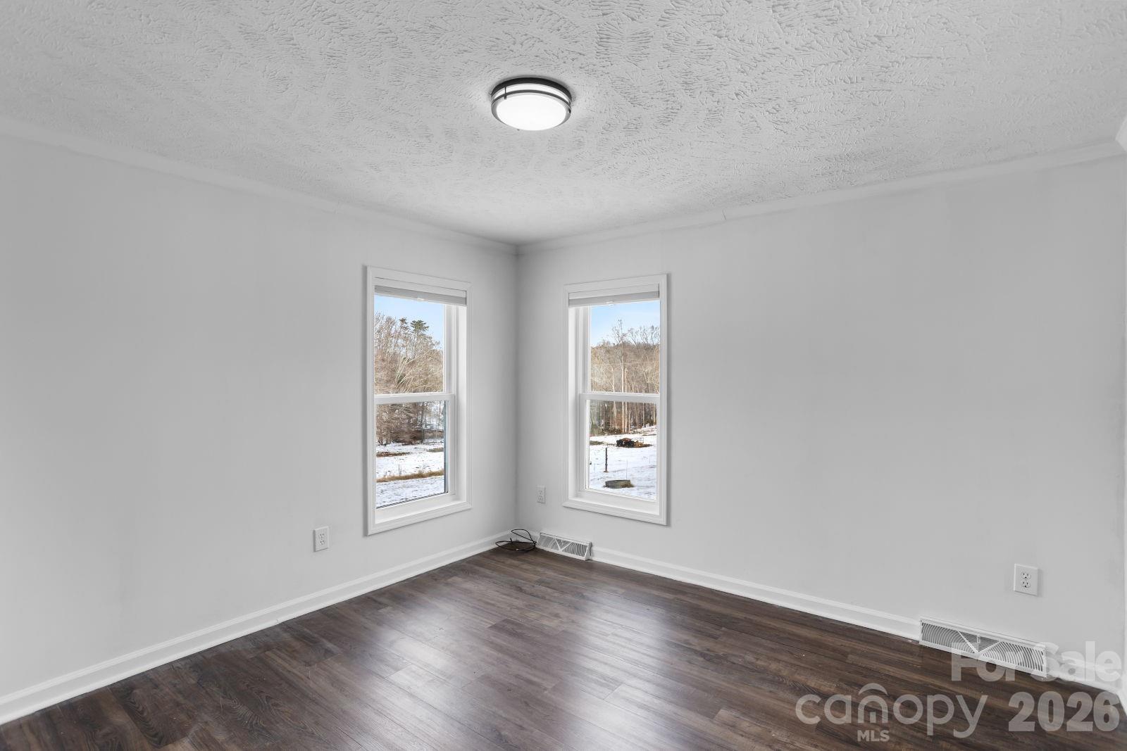 4855 Talley Road Walkertown, NC 27051 - Photo 35 of 45 an empty room with wooden floor and windows