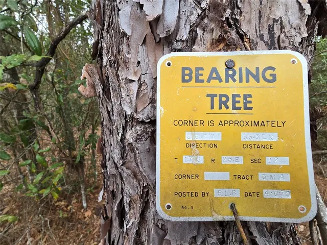 a sign on the wall with a couple of table and chairs