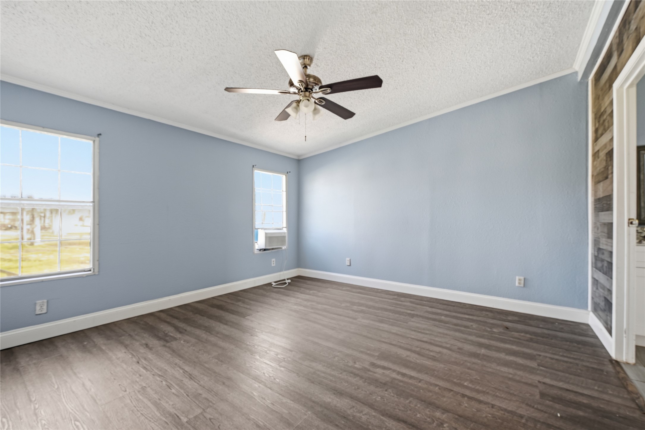 39512 Donigan Road Brookshire, TX 77423 - Photo 12 of 15 an empty room with wooden floor fan and windows