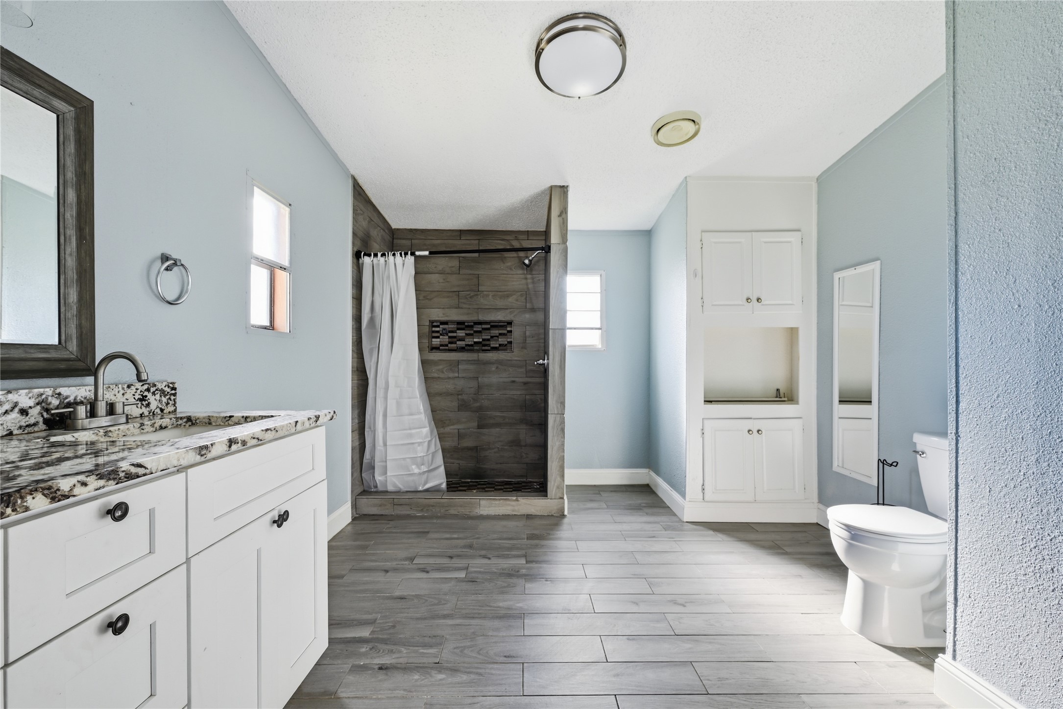39512 Donigan Road Brookshire, TX 77423 - Photo 13 of 15 a spacious bathroom with a double vanity sink a toilet and a shower