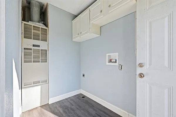 a view of storage and utility room with wooden floor