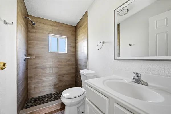 a bathroom with a sink toilet and shower