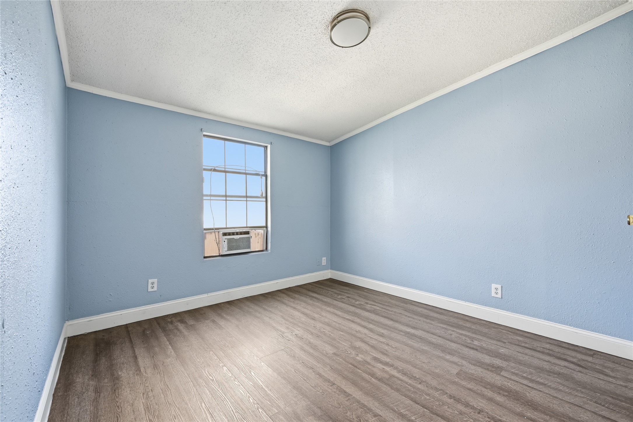 39512 Donigan Road Brookshire, TX 77423 - Photo 8 of 15 an empty room with wooden floor and windows