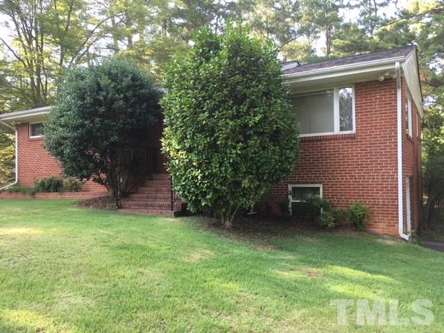 1916 French Drive Raleigh, NC 27612 - Photo 2 of 4 a view of a backyard with table and chairs and a large tree
