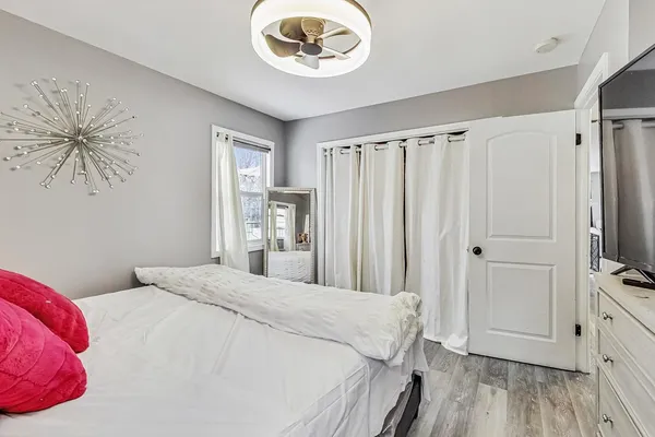 a bedroom with a bed and a chandelier