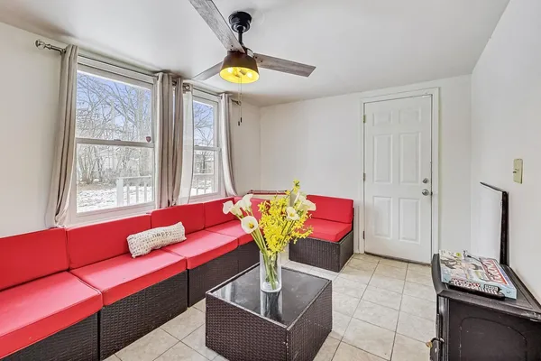a living room with furniture and painting on the wall