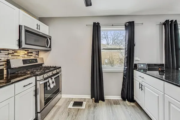 a kitchen with stainless steel appliances granite countertop a stove top oven and sink