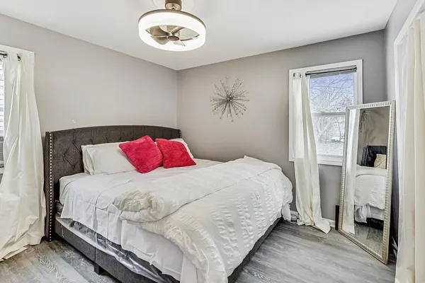 a bedroom with a bed and a chandelier