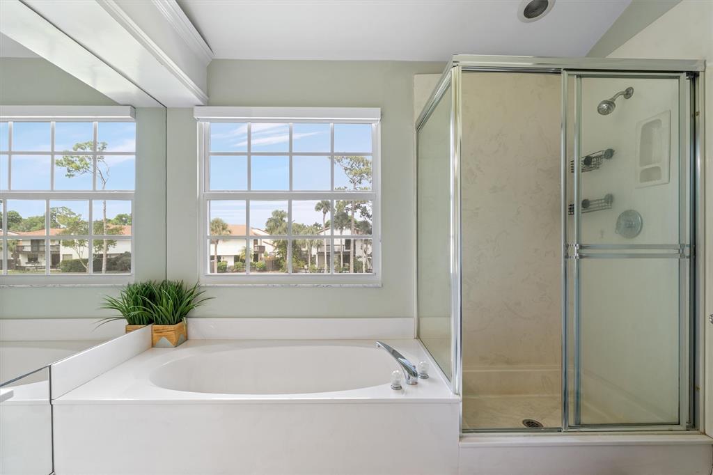 21470 St Andrews Grand Circle, Unit 12 Boca Raton, FL 33486 - Photo 17 of 26 a white bath tub sitting next to a window