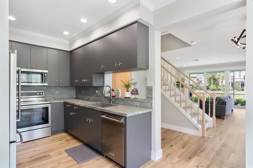 21470 St Andrews Grand Circle, Unit 12 Boca Raton, FL 33486 - Photo 8 of 26 a view of a kitchen with a sink and cabinets