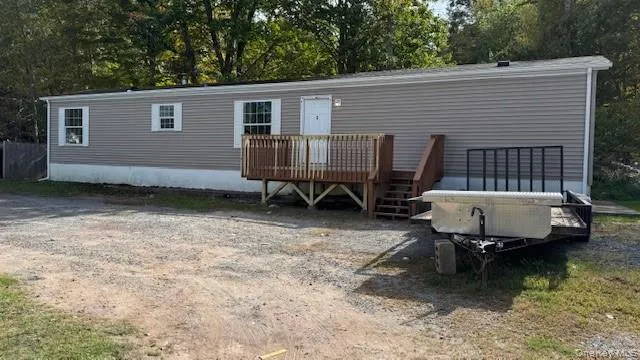 a backyard of a house with barbeque oven table and chairs