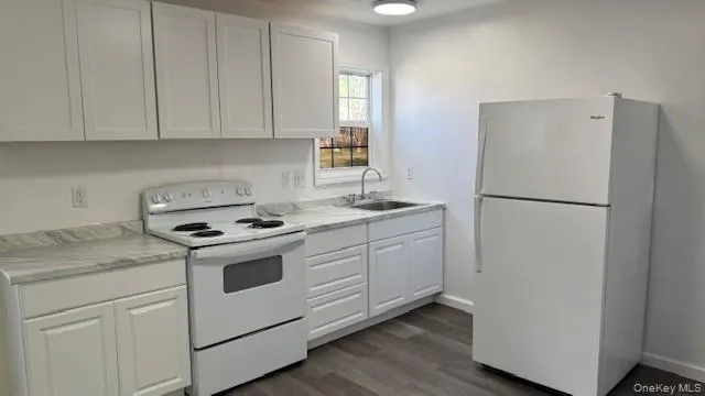 a kitchen with a refrigerator sink stove and cabinets