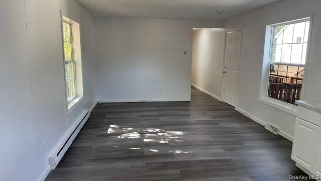 a view of an empty room and wooden floor