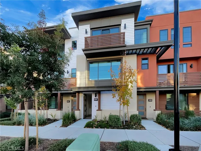 a front view of a house with plants and entryway