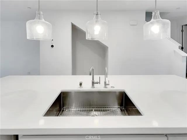 a kitchen with white cabinets and appliances