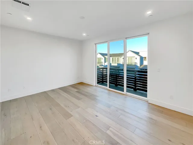 a view of a room with wooden floor and a window