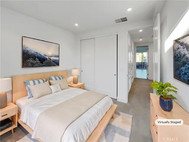 a spacious bedroom with a bed and a couch