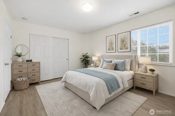 a bedroom with a bed and a large window