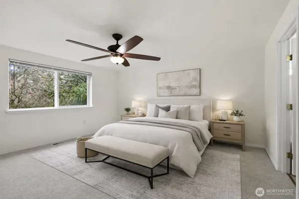 a room with a bed and a large window