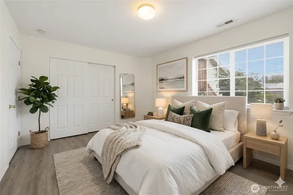 a bed room with a bed and a potted plant