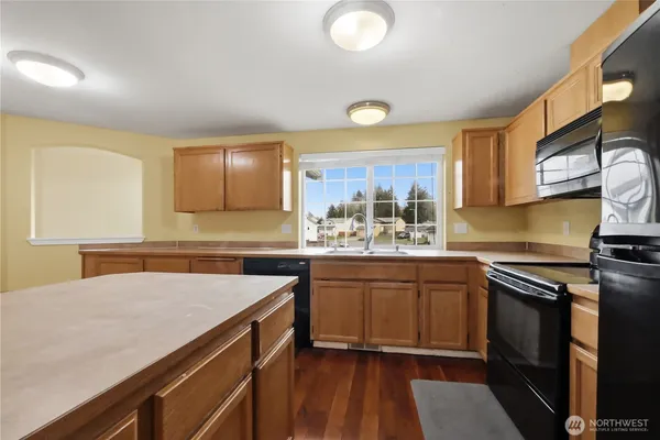 a kitchen with a sink appliances and cabinets