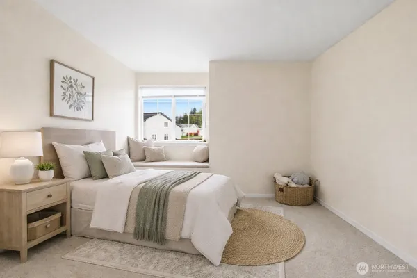 a bedroom with a bed and a painting on the wall