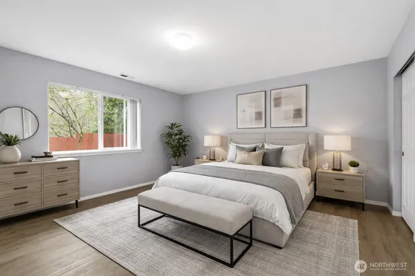 a spacious bedroom with a bed and window