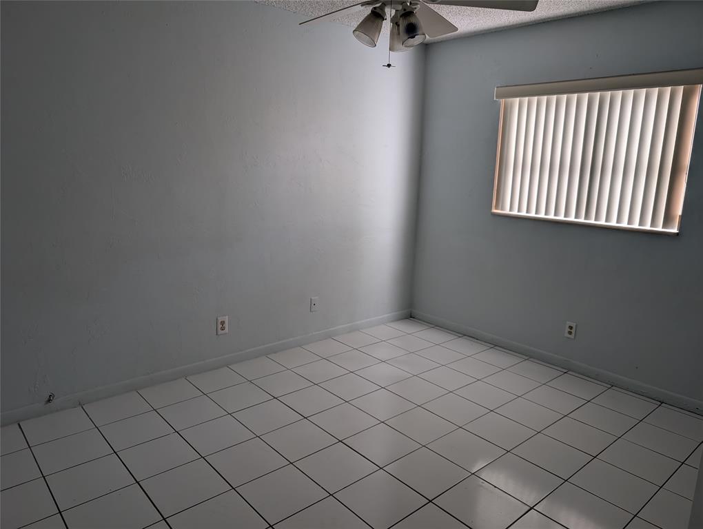 7502 Northwest 44th Court, Unit B Coral Springs, FL 33065 - Photo 7 of 15 an empty room with windows