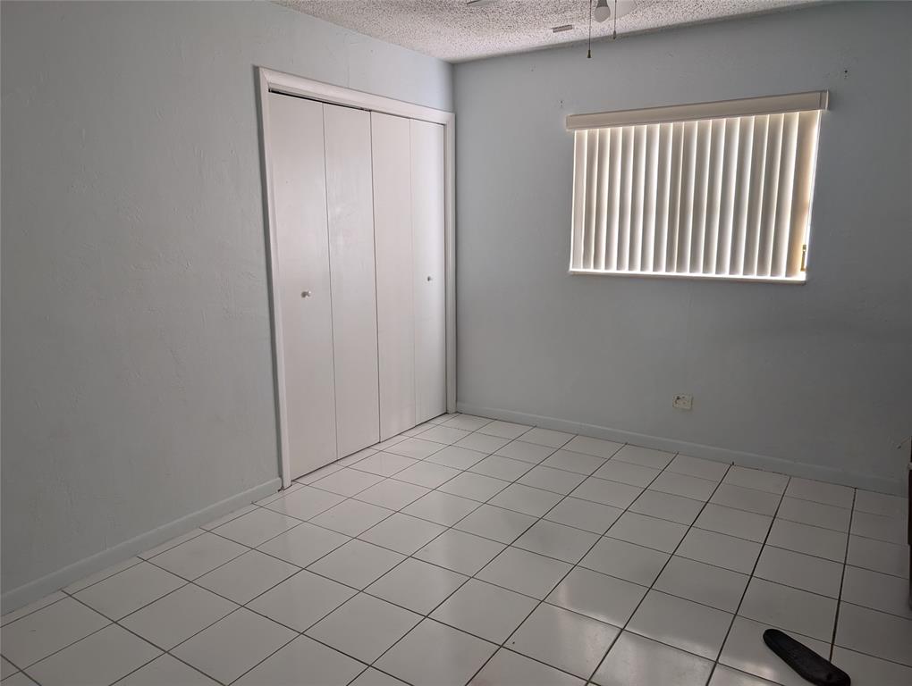 7502 Northwest 44th Court, Unit B Coral Springs, FL 33065 - Photo 8 of 15 an empty room with windows