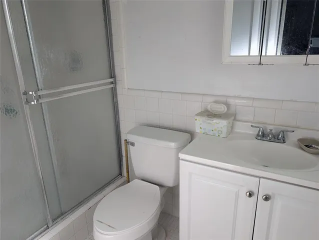 a bathroom with a shower and a toilet