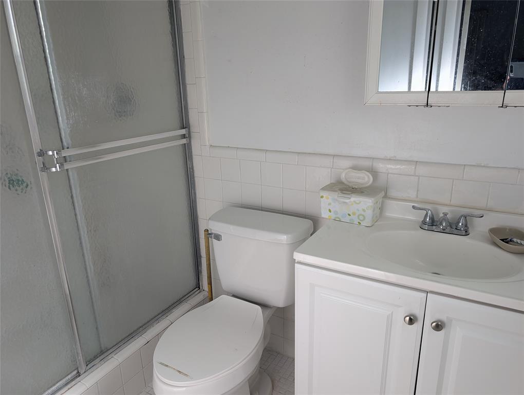 7502 Northwest 44th Court, Unit B Coral Springs, FL 33065 - Photo 9 of 15 a white toilet sitting next to a bathroom sink